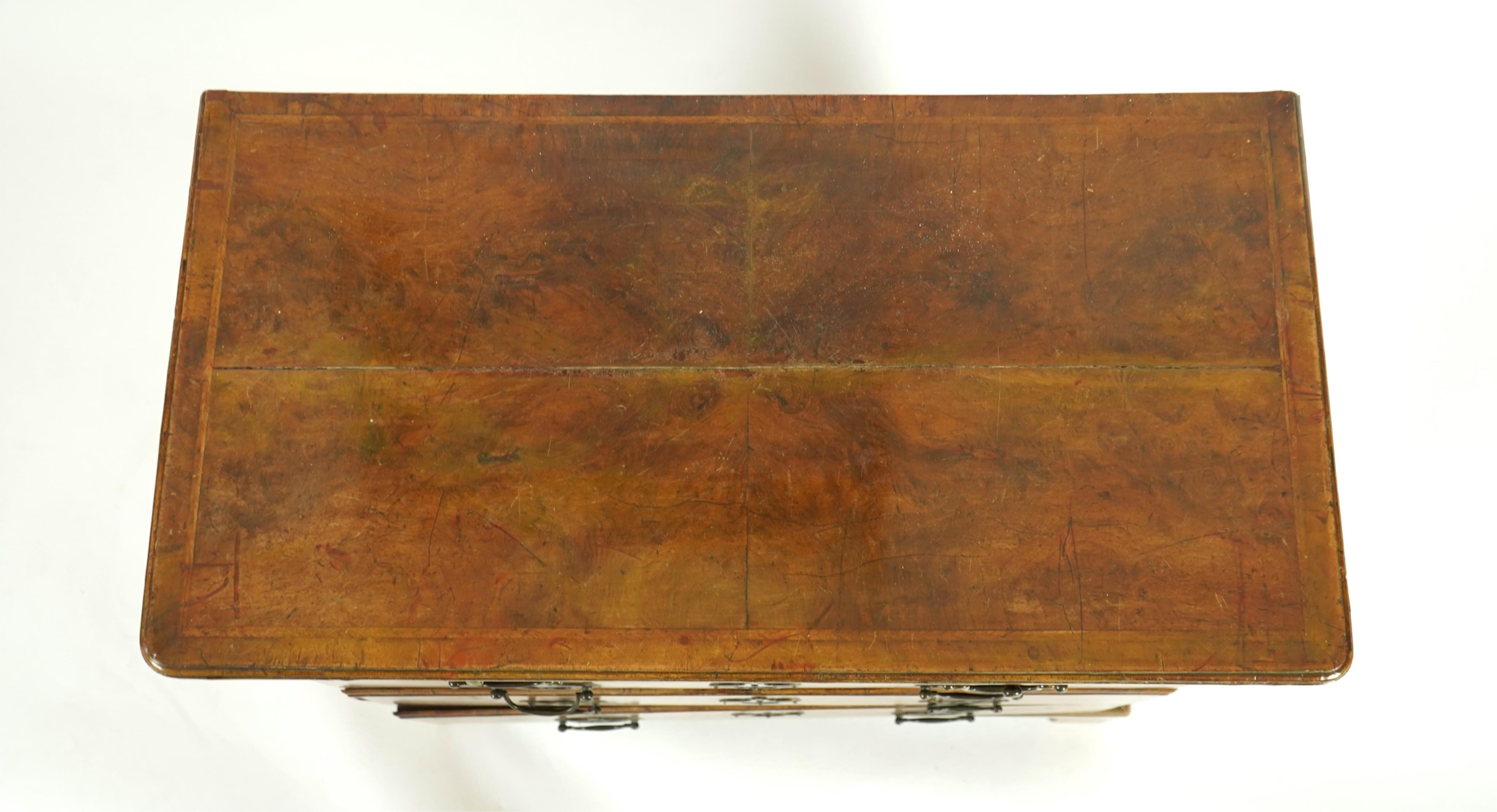 A small early 18th century and later cross and feather banded walnut veneered chest